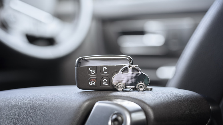 A car key fob left inside the vehicle, sitting on the center console.