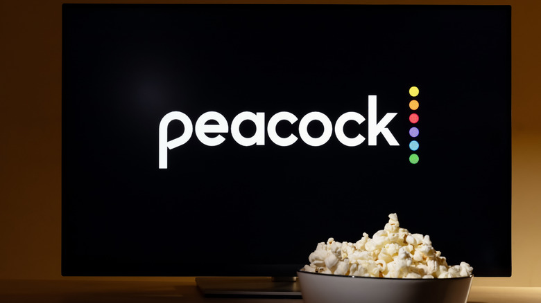Peacock logo pictured behind a bowl of popcorn