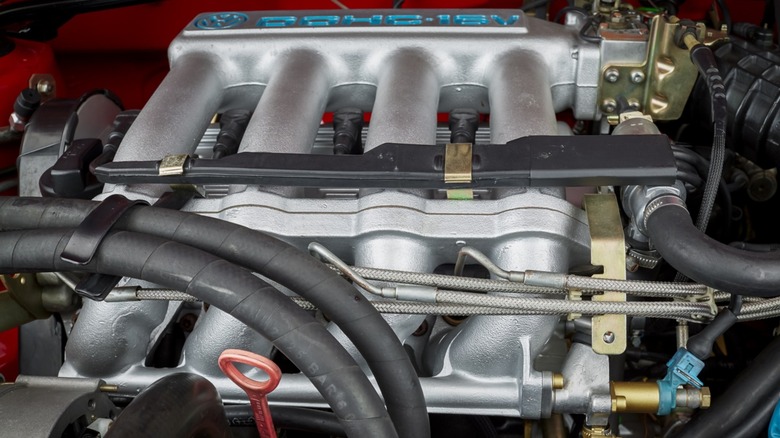 Exposed aluminum intake manifold ports on a car engine.