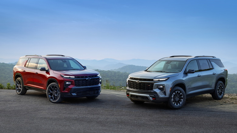Red and silver Chevrolet Traverses parked on a hillside