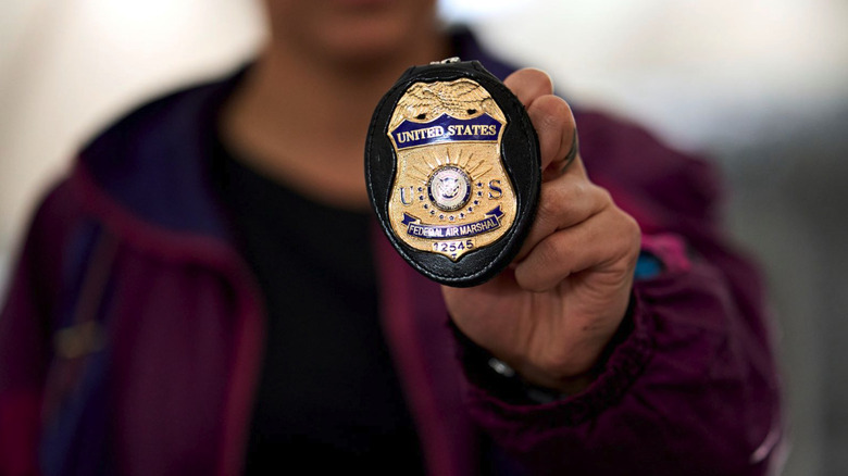 Federal Air Marshal holding badge