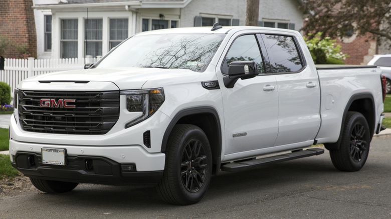 2024 GMC Sierra Elevation Crew Cab parked on one side of street with a building in the background