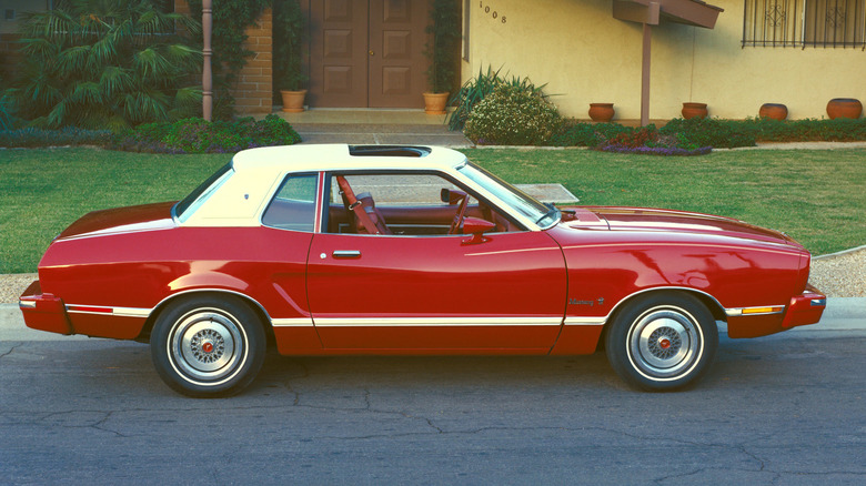 1974 Ford Mustang II parked on street in front of house, right-side view