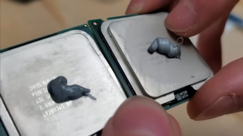 Two processors with thermal paste applied to them, side by side