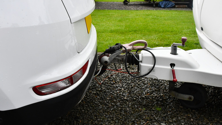 a caravan attached to a car by a towbar
