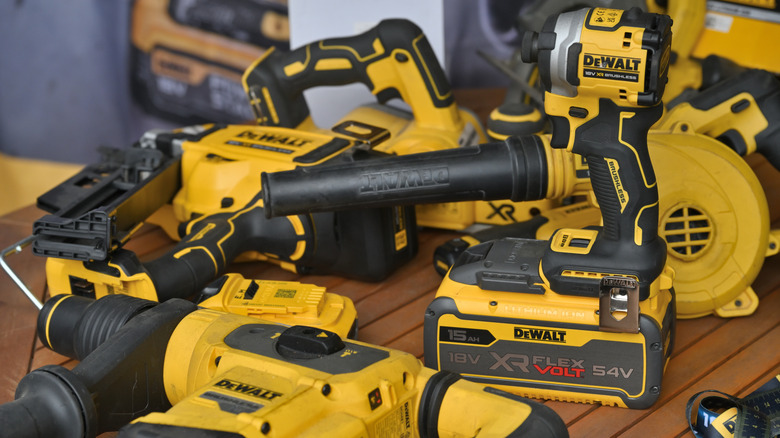 Table covered in various DeWalt power tools