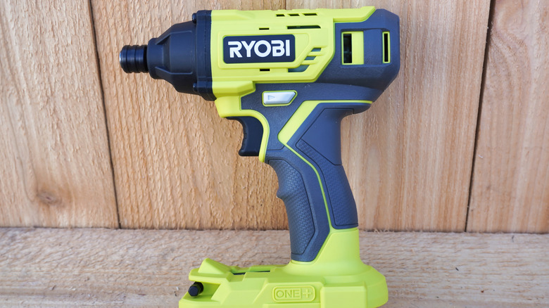 A Ryobi drill against a wall.