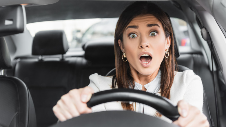 A woman who seems to be terrified while driving car