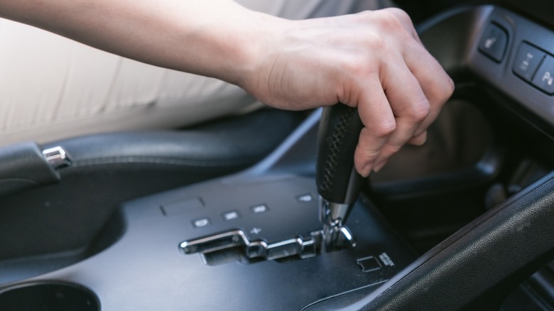 Driver holds on to the shift lever of the automatic transmission