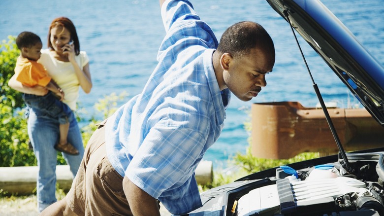 Man under car hood