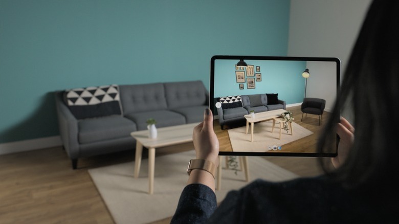 Person using an iPad to create a 3D scan of furniture