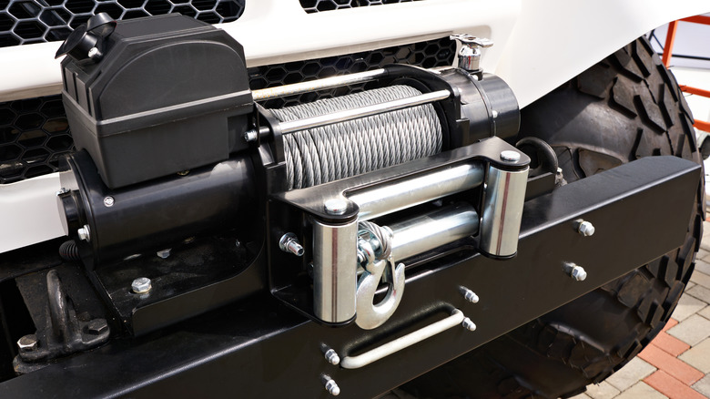 Close-up of a steel wire rope winch installed on a car