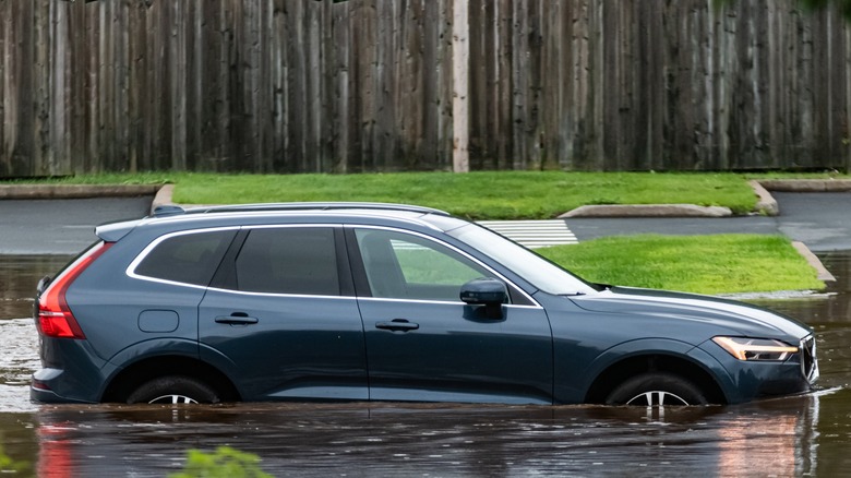 SUV driving through flood