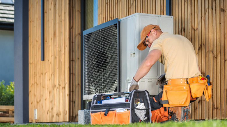 A technician working on a heat pump