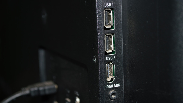 The side of a flatscreen TV showing two USB ports and an HDMI port.