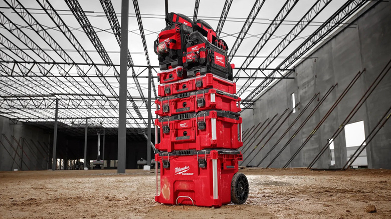 A tower of red Milwaukee tool boxes in a building site