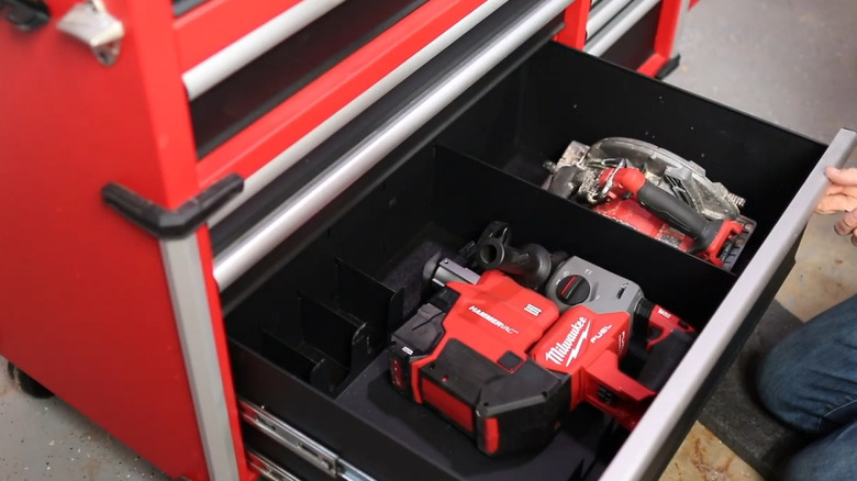 A couple heavy looking tools in the bottom drawer of a tool chest
