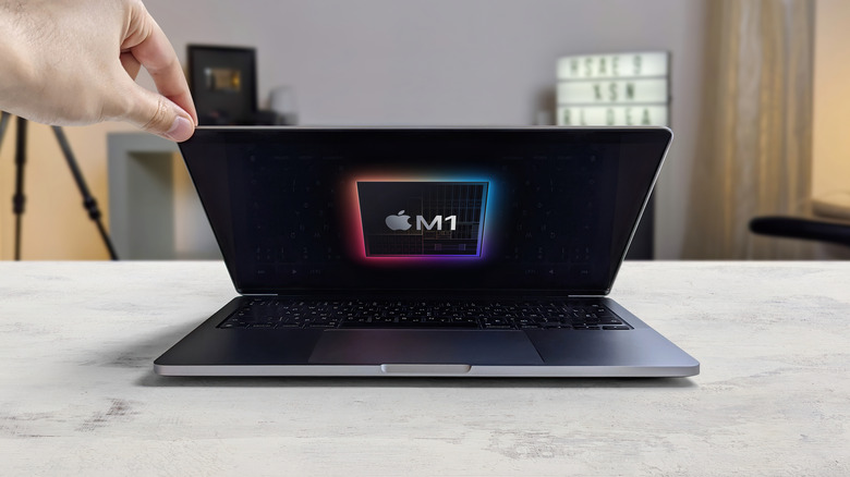 Man opening an M1 powered MacBook Pro