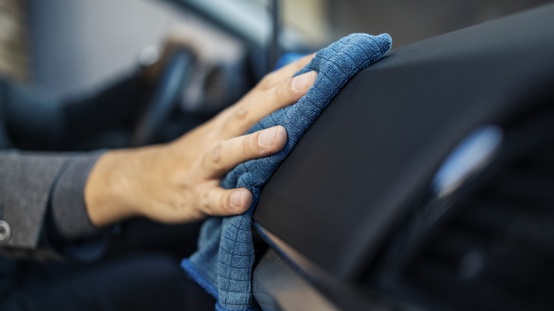 washing car dashboard with cloth
