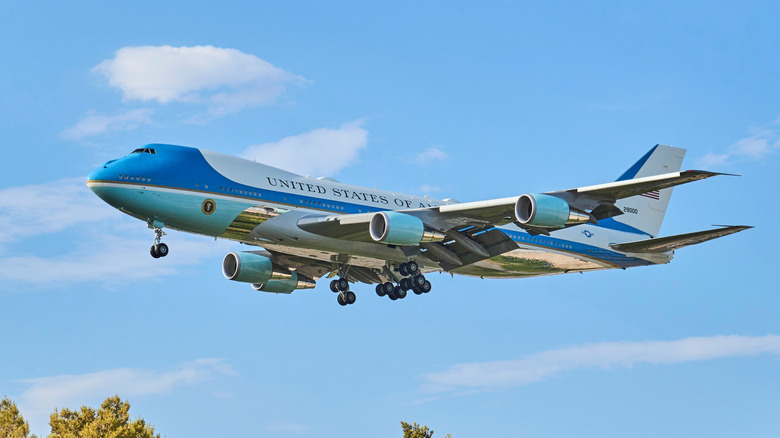 Blue Air Force One Boeing aircraft flying low with landing gear deployed