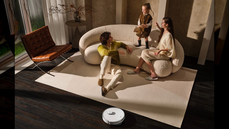MOVA robot vacuum and mop in use as family relaxes on couch