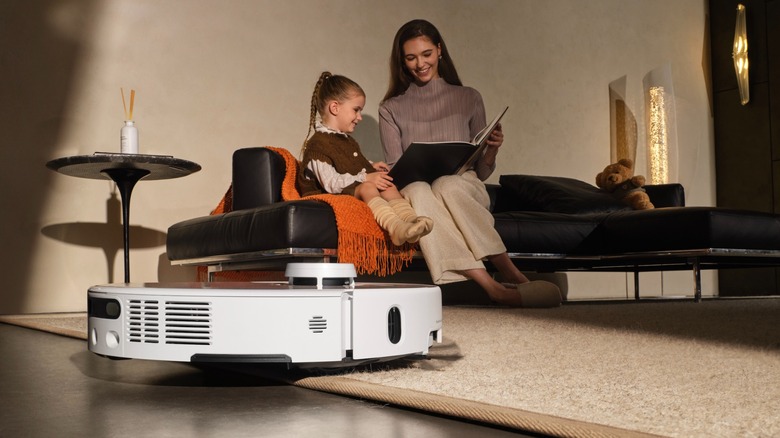 MOVA P50 Pro Ultra crossing over a carpet as a mother reads to her daughter