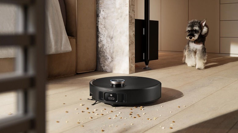 MOVA V50 Ultra Complete cleaning debris as a dog looks on