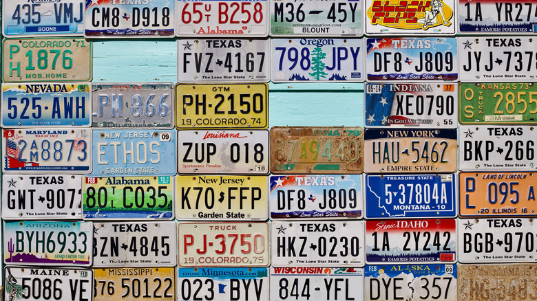 A wall of license plates from different states.