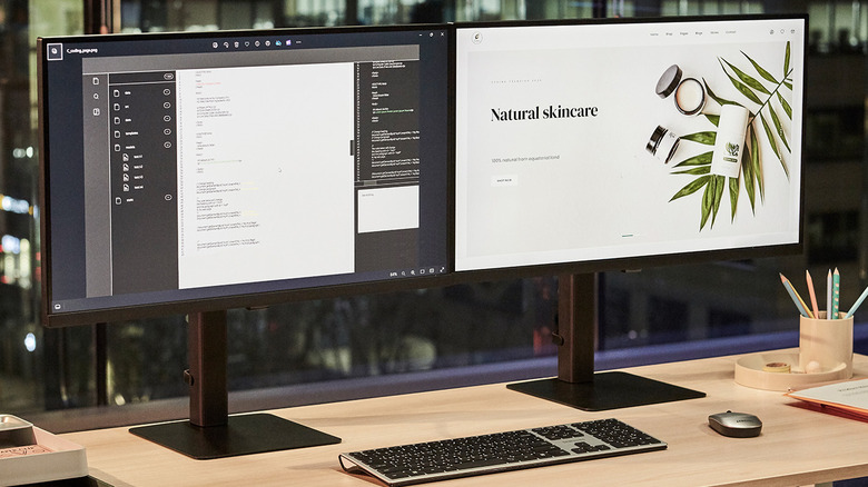 Two computer monitors side by side on an office desk