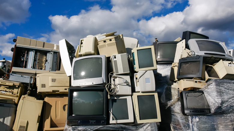 A pile of computer monitors, TVs, and printers