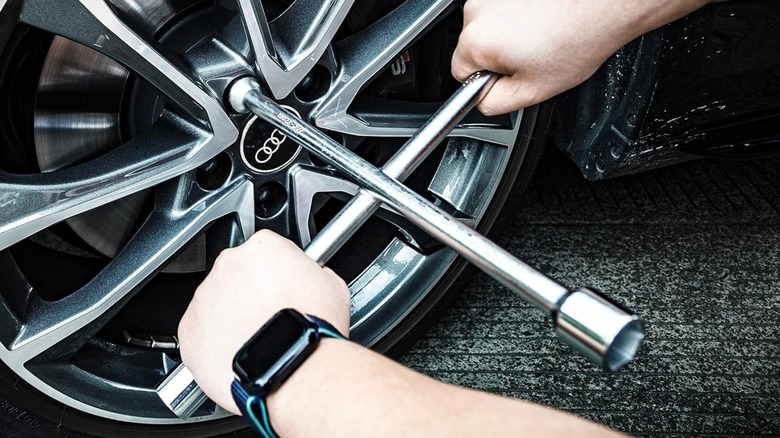 Lug wrench in use on a tire