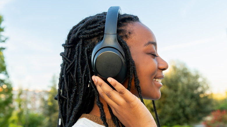 Person wearing headphones and smiling