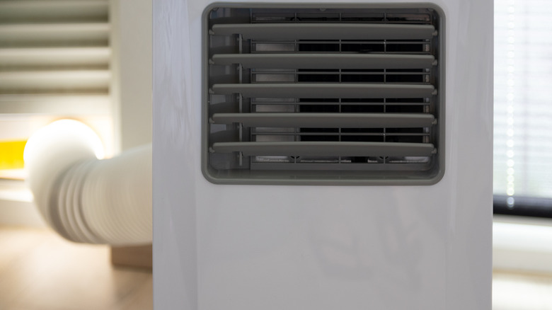 Close-up of single hose portable air conditioner.