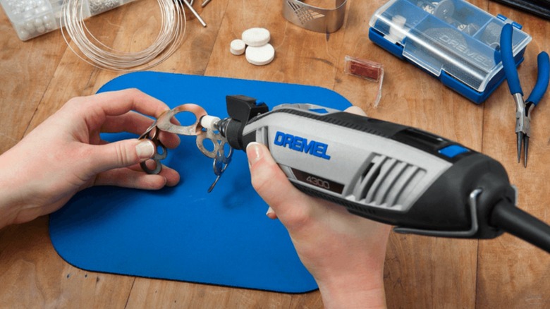 Person using Dremel rotatry tool to polish metal