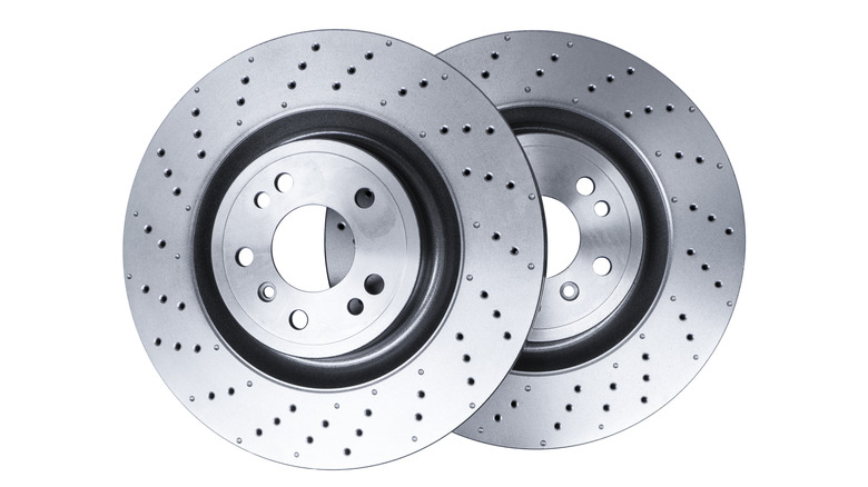 Two drilled brake rotors side-by-side against white background
