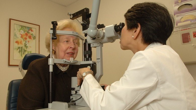 A doctor giving a woman an eye exam.