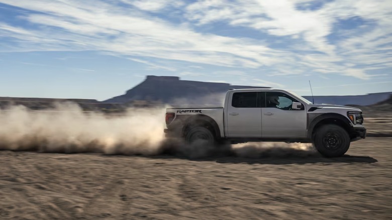 White Ford F-150 Raptor on sand