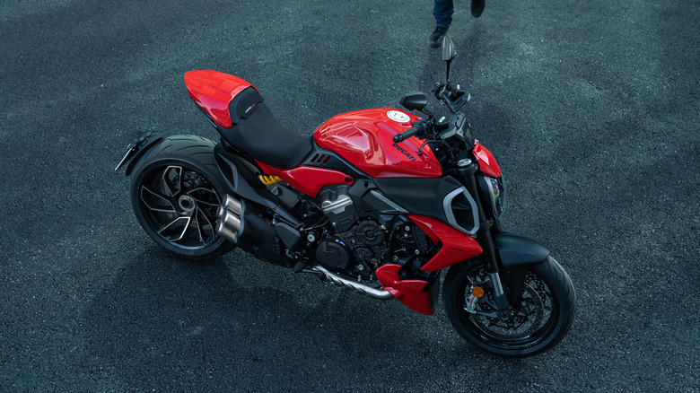 Ducati Diavel V4 parked with a rider approaching