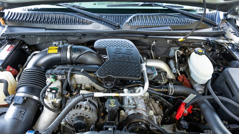 An open truck hood revealing a 6.6L Duramax diesel engine