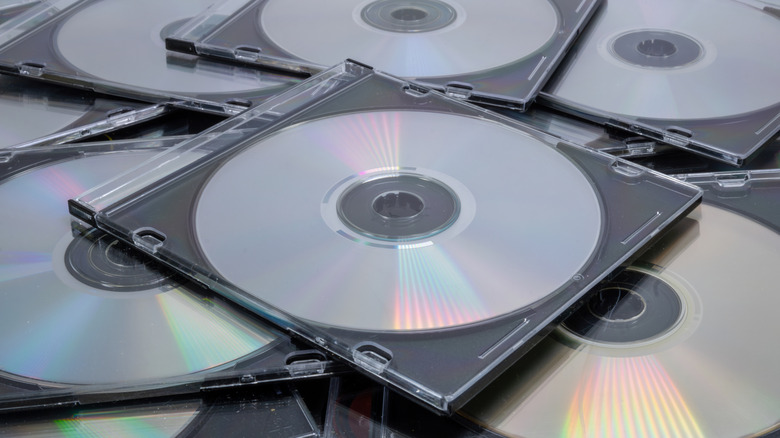 A pile of CD cases with CDs in them