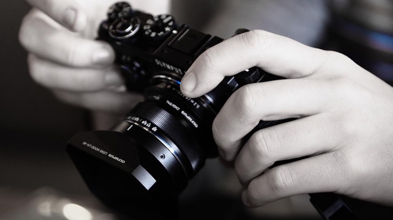 Mirrorless camera in hands