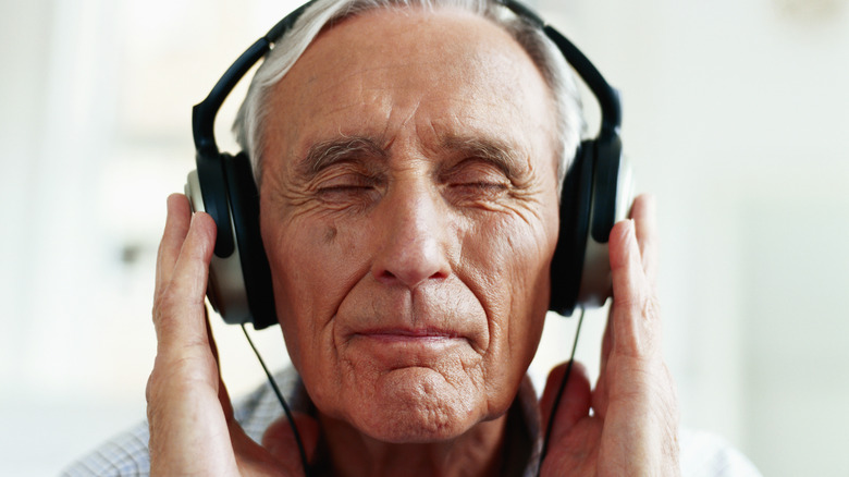old man wearing headphones