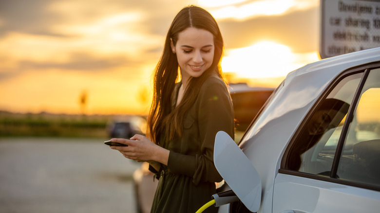 woman with hybrid car