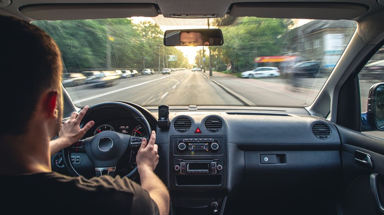 person driving down road