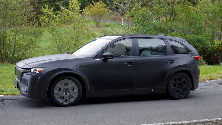 Side view of a gray Mazda chassis-testing-mule