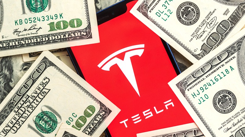 Tesla app surrounded by money