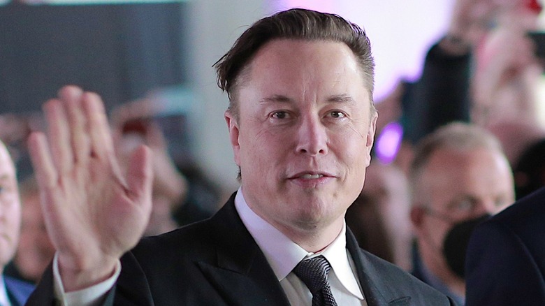 Elon Musk waving at camera.