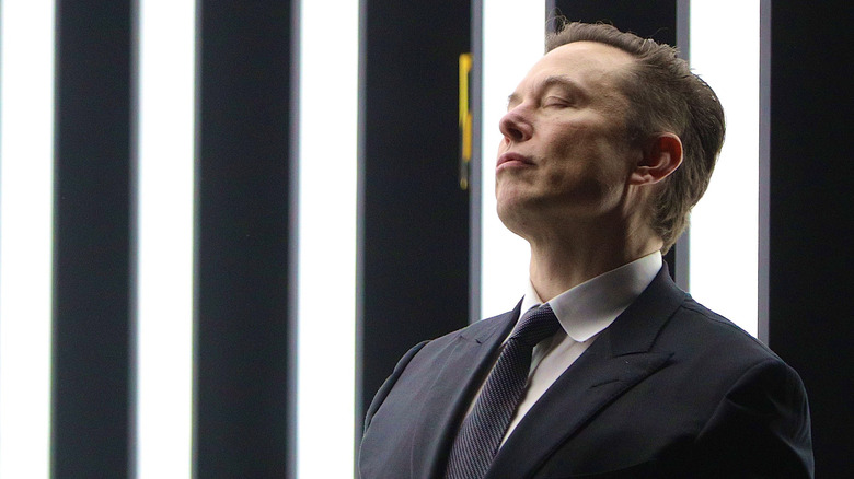 Elon Musk thinking with eyes closed.