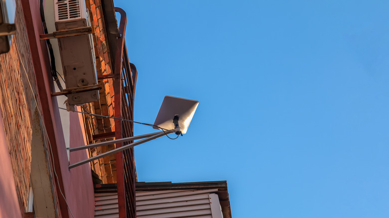 Starlink dish mounted on exterior of apartment building