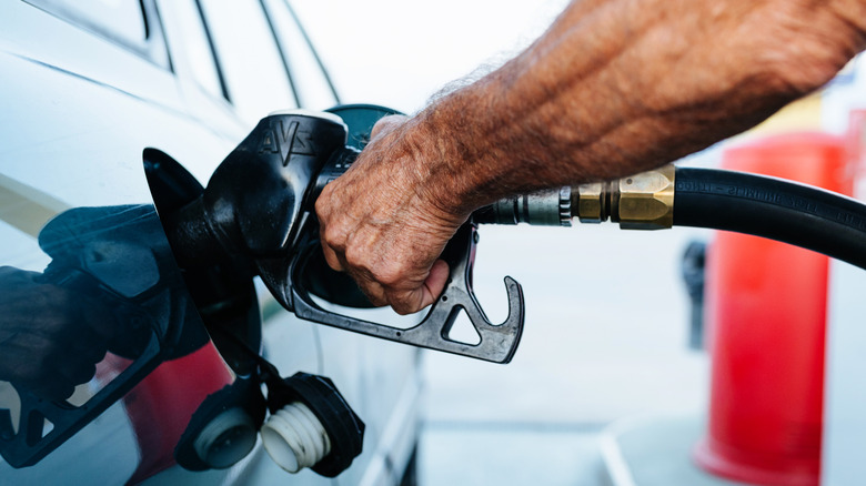 Close up of person pumping gas